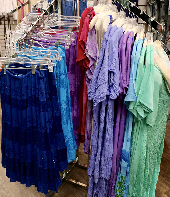 skirts and blouses on a rack