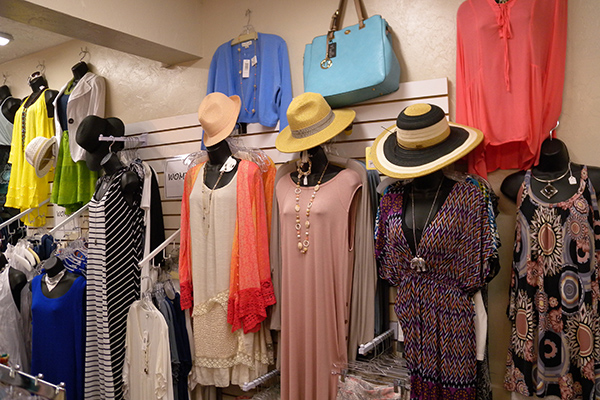 dresses and hats hanging on a wall